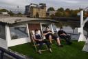 Vic, Dan and Zoya Rossi enjoy the sunshine from atop the boat's roof