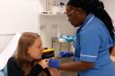 Natalie Haggis gets the vaccination from nurse Anne Opute at Queen's  antenatal clinic