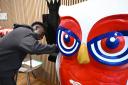 Arsenal's Bukayo Saka signs an owl sculpture ready for auction in aid of North London hospice