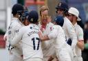 Simon Harmer celebrates with Essex teammates after taking a wicket against Hampshire