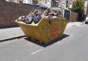 The skip on the road in St Chad's Gardens in Chadwell Heath