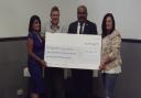 Cllr Peter Chand (second from right) presents a cheque to representatives from the Dagenham-based Independent Living Agency.