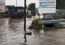 Vehicles driving through flood water in Renwick Road.