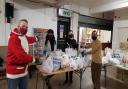 Leader of the council, Cllr Darren Rodwell, with Youth League UK programme manager John Wainaina and volunteers pack food and essentials.