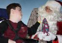 Logan Johnson receives a present from Santa