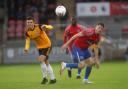 Dagenham & Redbridge captain Matt Robinson battles for the ball against Woking