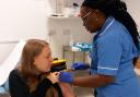 Natalie Haggis gets the vaccination from nurse Anne Opute at Queen's  antenatal clinic