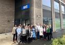 Guests at the official opening of Beam Park Health Centre gather outside the building along with GP partners from Beam Park Medical Practice and staff from North East London NHS Foundation Trust (NELFT)