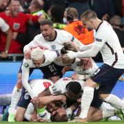 England's Harry Kane is mobbed by team-mates after scoring their side's second goal of the game in extra-time during the UEFA Euro 2020 semi final match at Wembley Stadium, London. Picture date: Wednesday July 7, 2021.