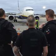 Police officers arrested a man as he stepped off a flight at Stansted Airport