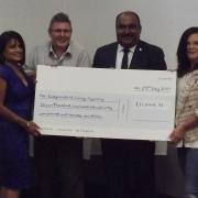 Cllr Peter Chand (second from right) presents a cheque to representatives from the Dagenham-based Independent Living Agency.