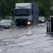 Vehicles navigate flooding near Gants Hill Roundabout on Sunday, July 25.