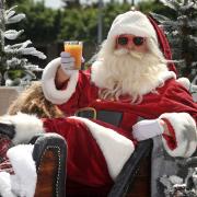 Santa donned his shades and enjoyed a drink after landing at Mecca Bingo Dagenham to launch 'Junemas'.