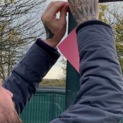 A student ties up a message of hope.