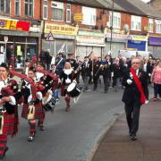 The Dagenham Girl Pipers lead this morning's Remebrance Sunday march through Dagenham.