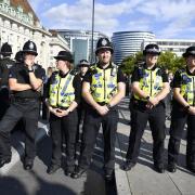 Police with members of the public who are waiting in line to view Queen Elizabeth II lying in state in Westminster Hall ahead of her funeral on Monday.