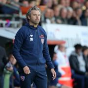 Dagenham & Redbridge boss Daryl McMahon looks on