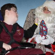 Logan Johnson receives a present from Santa