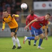 Dagenham & Redbridge captain Matt Robinson battles for the ball against Woking