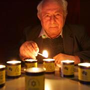 Henry Ganz who escaped the Nazis in 1939 lights memorial to the six million murdered Jews