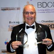 Farley Shelkin proudly holds the two awards won by his business Dagenham Travel