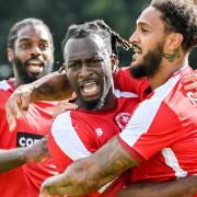 Martell Taylor-Crossdale (centre) celebrates his goal.