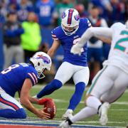 Buffalo Bills’ kicker Tyler Bass, centre, kicks a game-winning field goal against the Miami Dolphins (Adrian Kraus/AP)