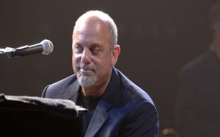 Billy Joel performs on stage at Wembley Arena in 2006