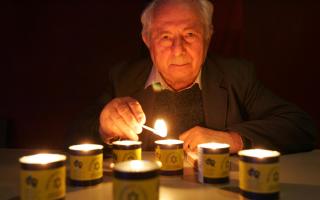 Henry Ganz who escaped the Nazis in 1939 lights memorial to the six million murdered Jews