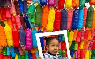 Esther Luke, 5, is one of the volunteers who helped paint plastic bottles for the sculpture