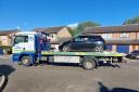 Police recovering the abandoned car in Plover Close, March.