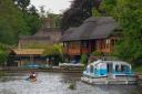 People enjoying a day out on boats on the Norfolk Broads.