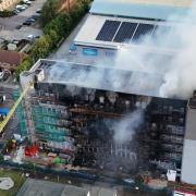 This dramatic photos shows severe fire damage to a block of flats on Freshwater Road in Dagenham today (August 26)