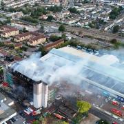 Dramatic photos reveal the severe damage to a block of flats by fire in Dagenham today (August 26)