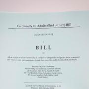 A person holding a hard copy of the Terminally Ill Adults (End of Life) Bill proposed by Labour MP Kim Leadbeater (PA)