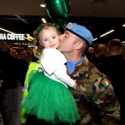 Corporal Paddy Brown with his daughter Molly after arriving home at Terminal 1 of Dublin Airport (Liam McBurney/PA)